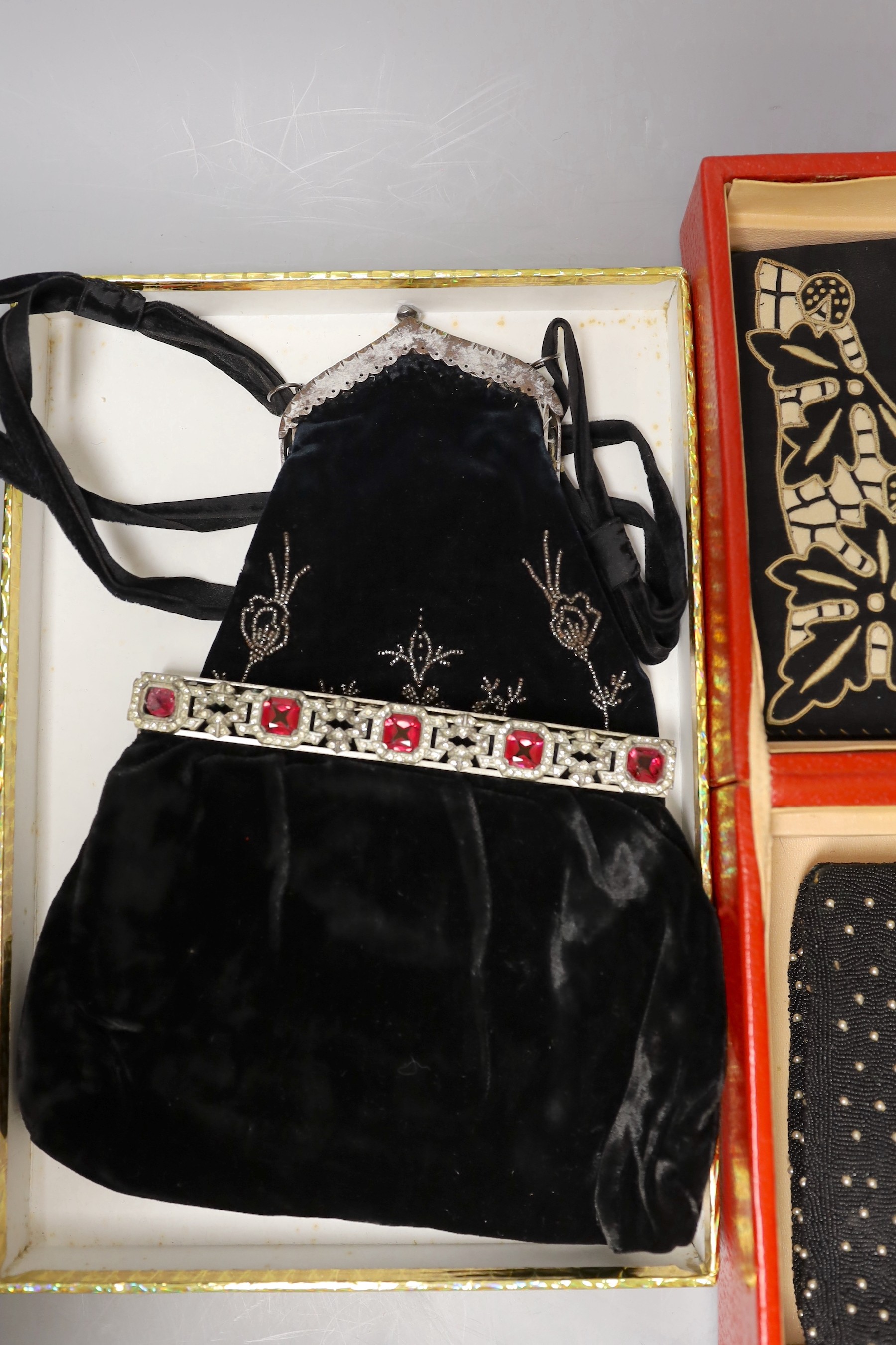 A 19th century cut steel, black velvet bag, a 1940’s-50’s diamanté handled clutch bag, 1930’s embroidered clutch bag, together with four later black beaded evening bags